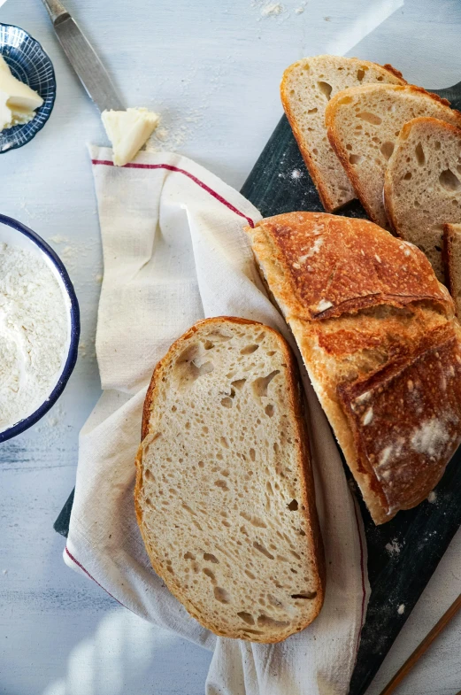 a table with slices of white bread and cheese