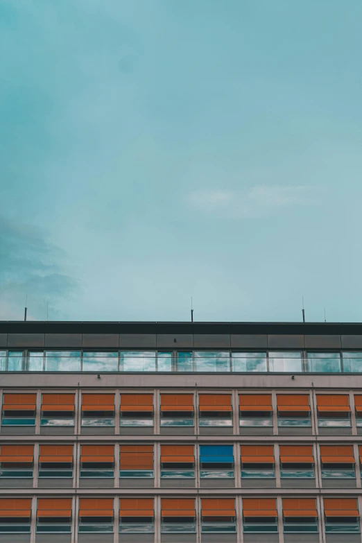 the plane is flying past a modern building