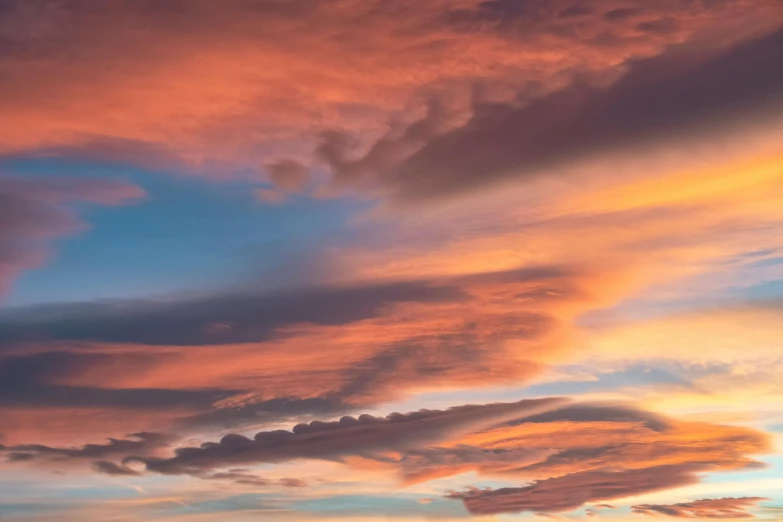 pink and blue clouds in the sky with yellows