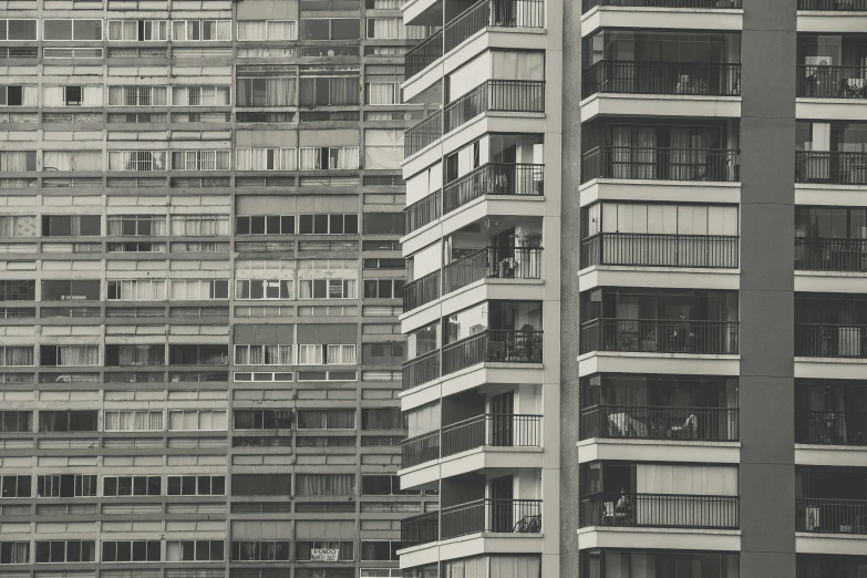 the side of several tall buildings have balconies