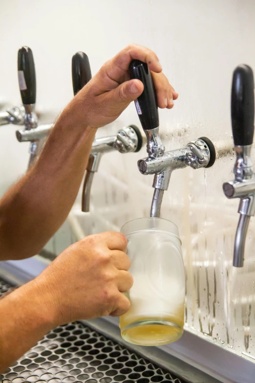 a man is filling a pint in a pub