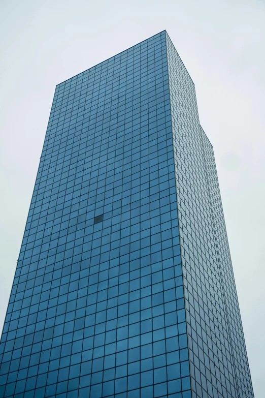 the top of an office building's blue glass windows