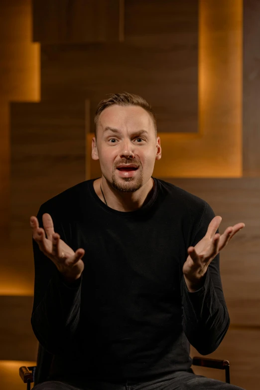 a man sits down with his hands open