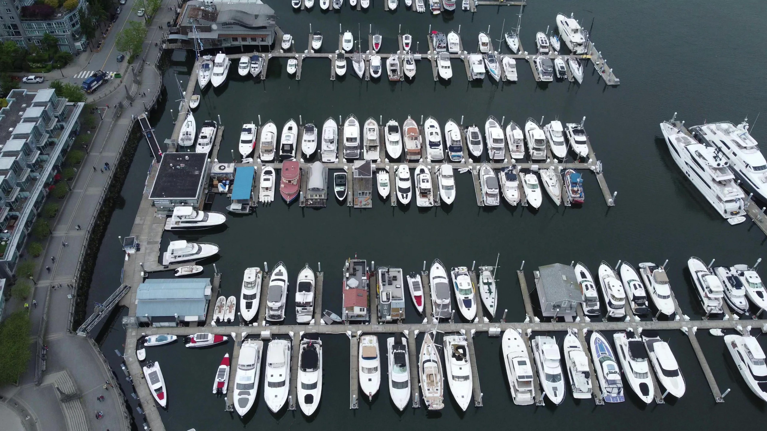 several motor boats are docked in a large body of water