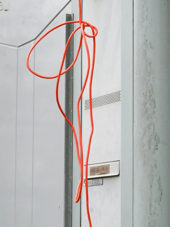 an orange string in between some doors on a building