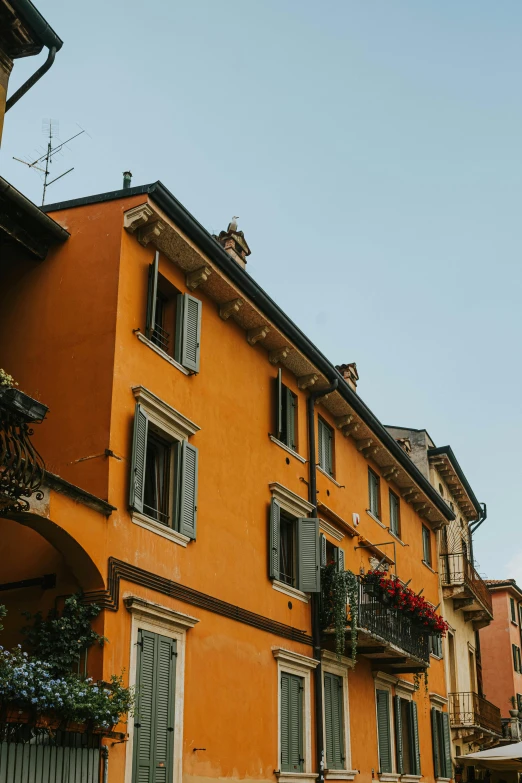 the orange building has two stories with many windows