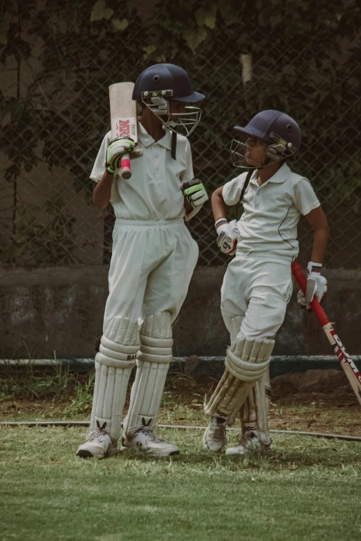 a little boy and girl playing cricket together