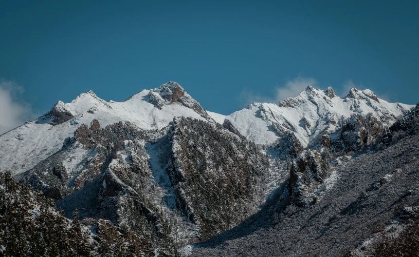 a very tall snowy mountain that looks majestic