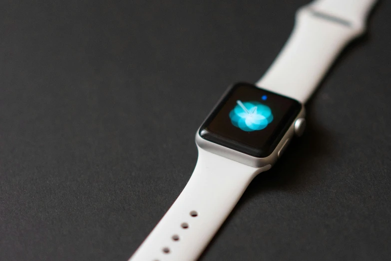 an apple watch with the logo apple on the screen