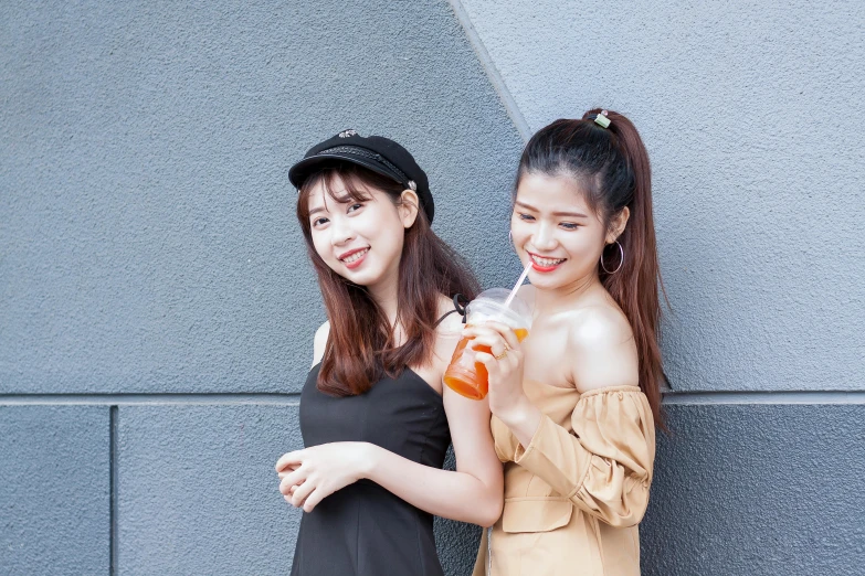 two women smile as they pose for a po