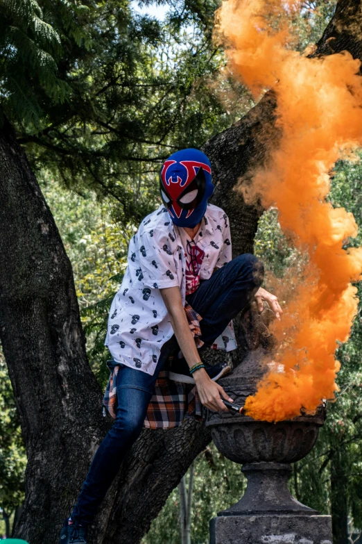 a man in a helmet is posing by the fire