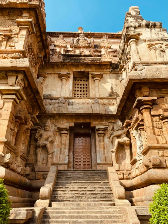 a staircase leading up to a tall castle like structure