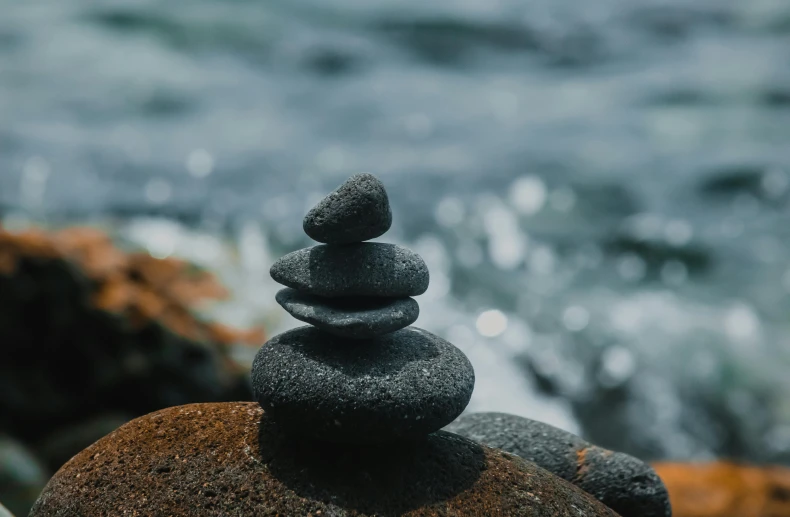 a close up of a group of rocks near the ocean