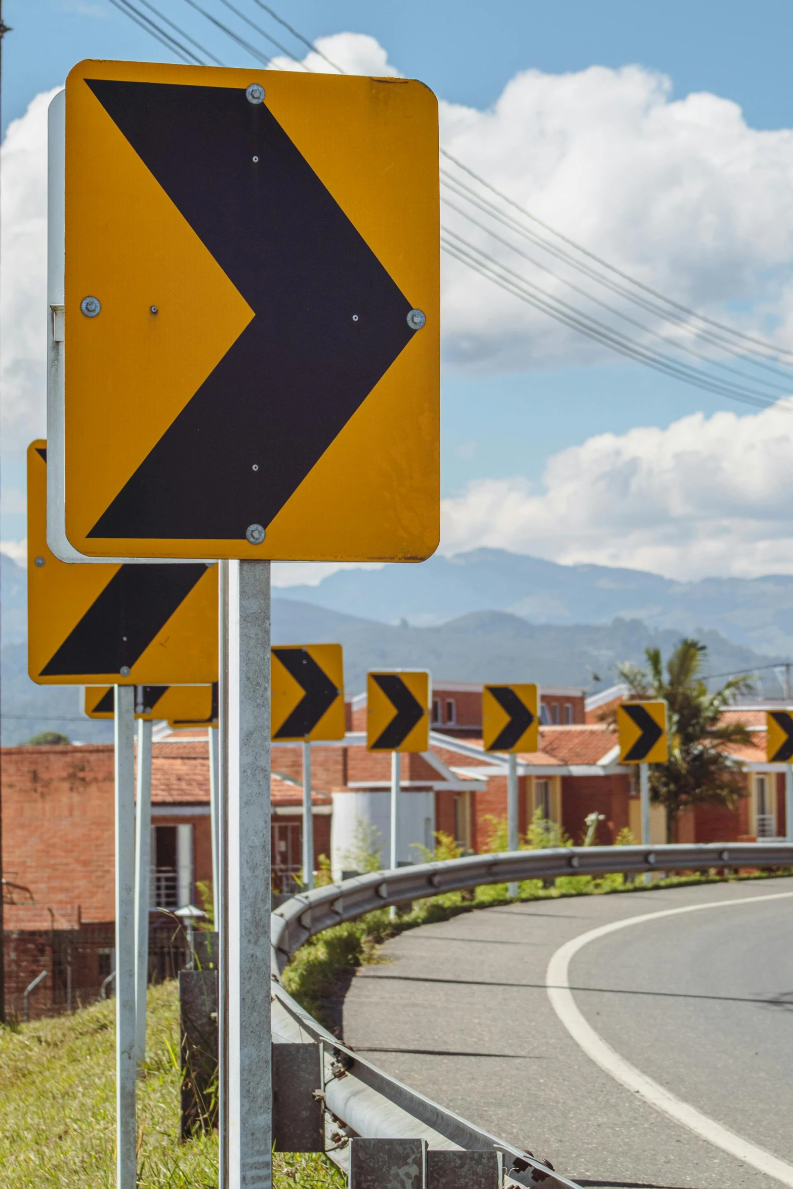 traffic signs point in various directions near an intersection