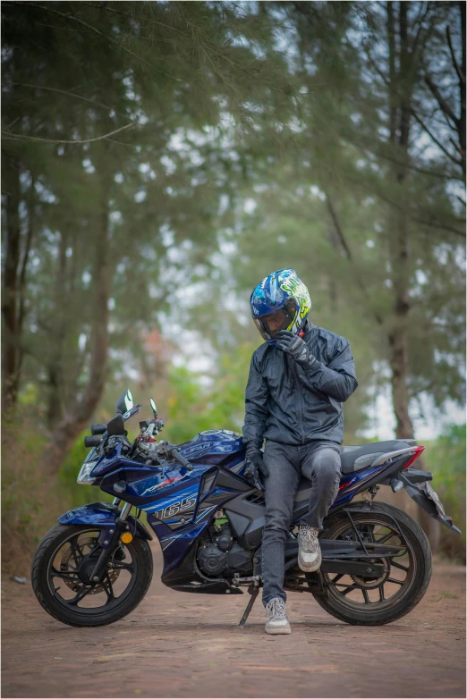 the man is sitting on the motorcycle with a helmet on