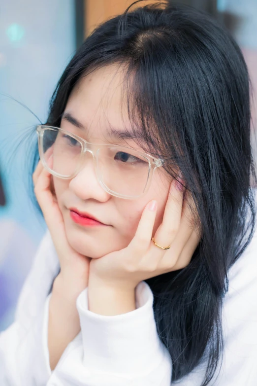 an asian woman with glasses and white shirt