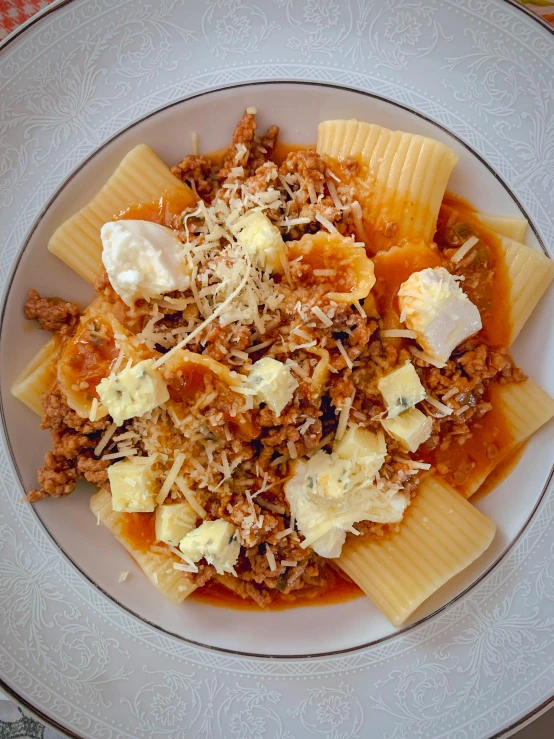 a plate with pasta and sauce on a table