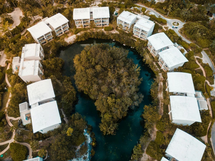 a lot of white buildings with water and trees around them