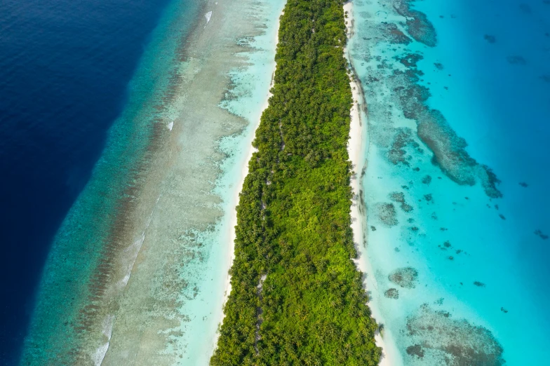 an aerial view of some green and white sand