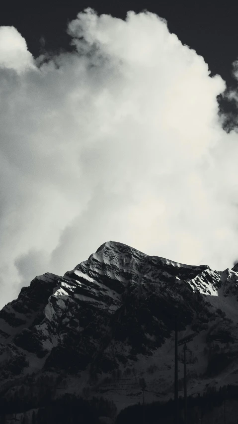 a po of the top of a mountain under clouds