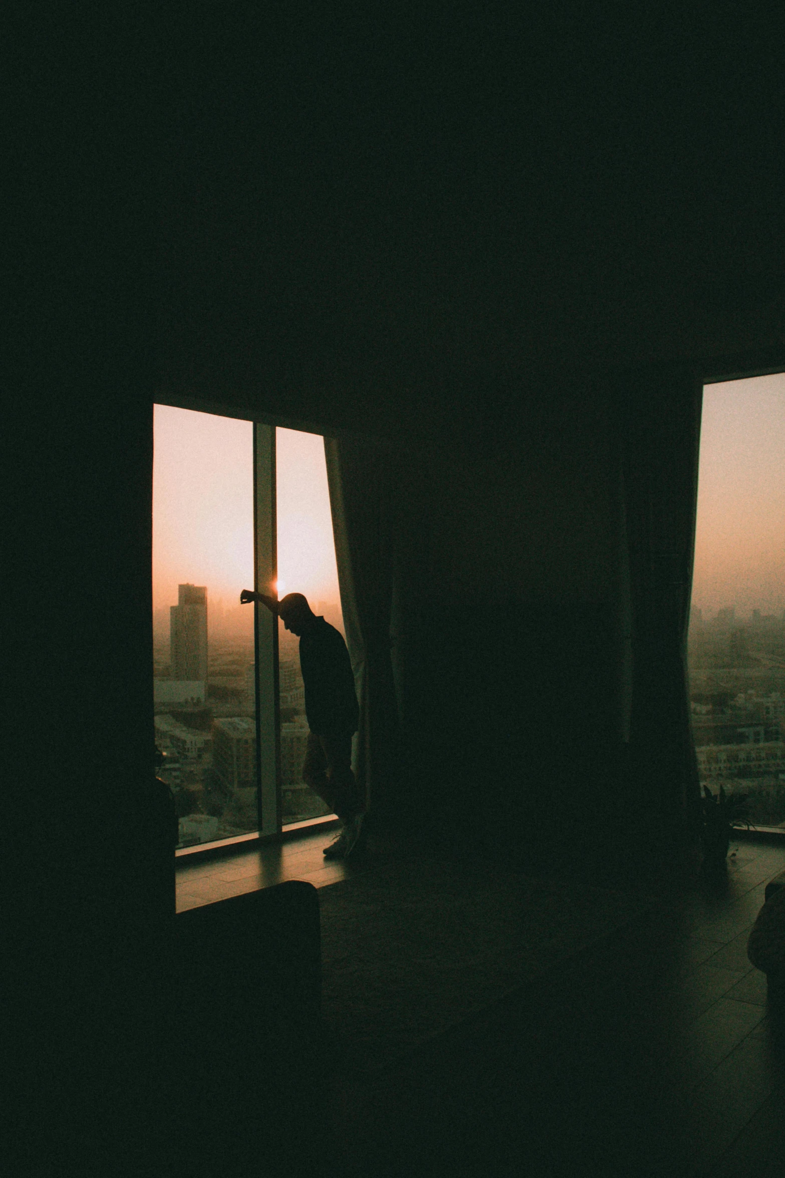 two people are standing outside the open window