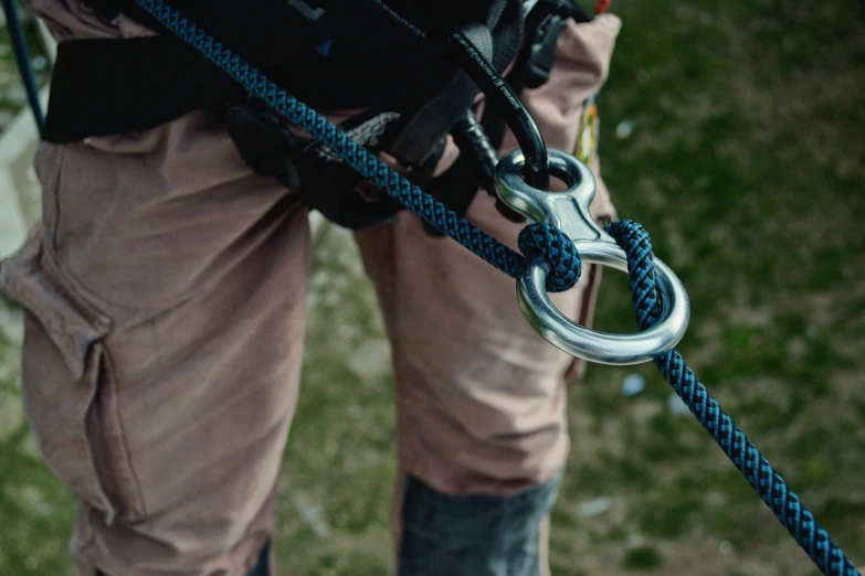 a person with safety equipment on holding the rope
