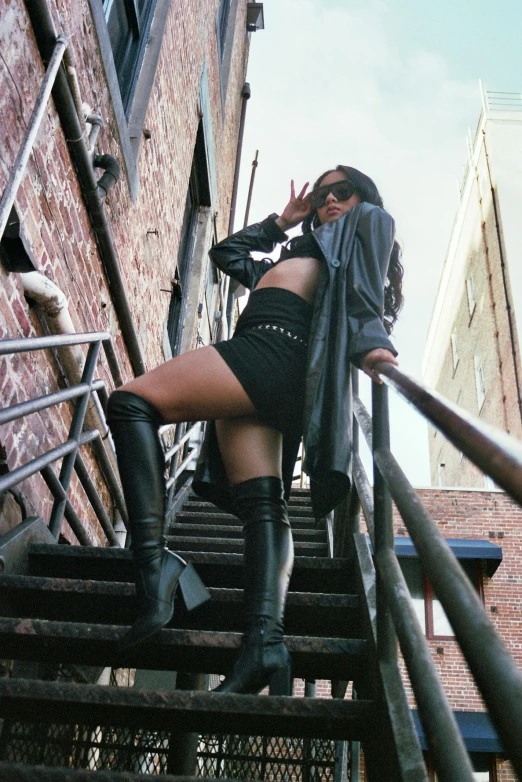 a woman wearing black boots on the stairs