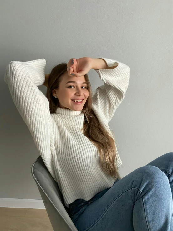 a woman posing in jeans on the ground