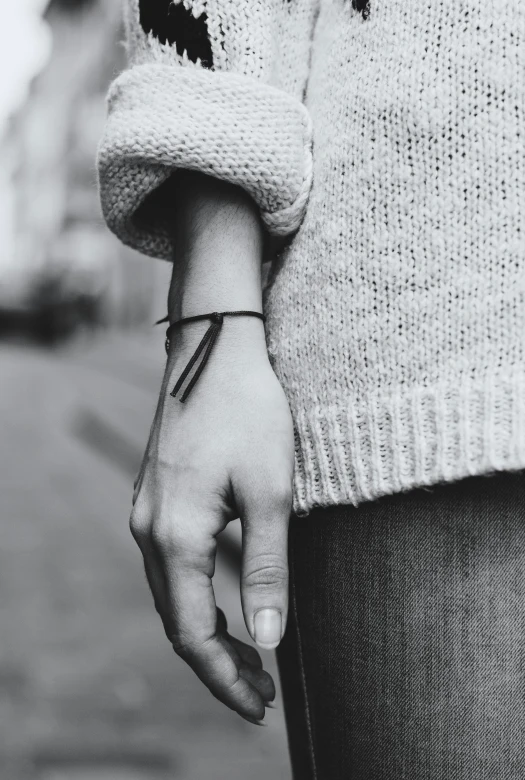 a close up of a person's wrist with a small black and white dot pattern on it