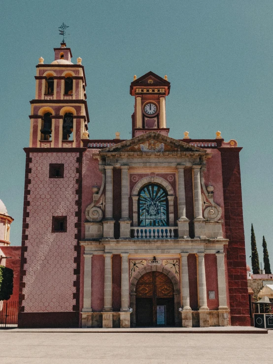 a church is on the corner with its bell tower