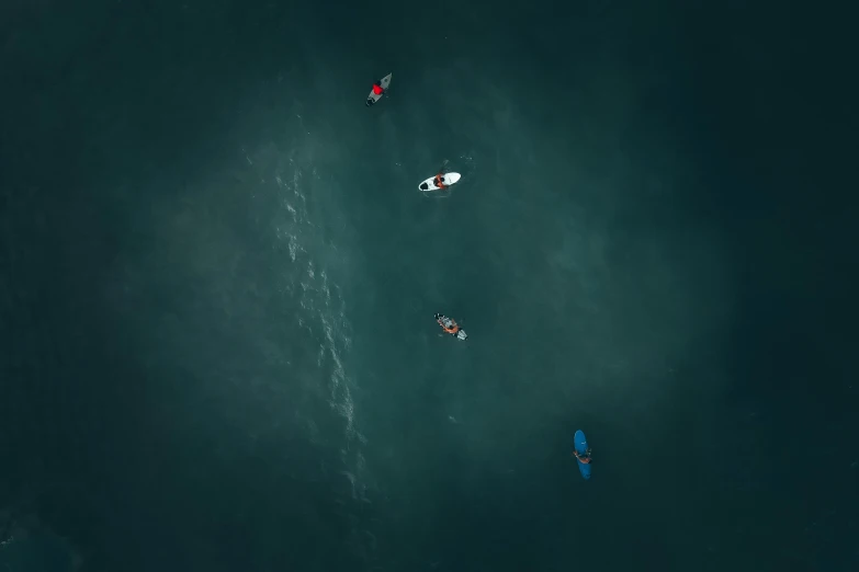 several boats are floating in clear water next to each other