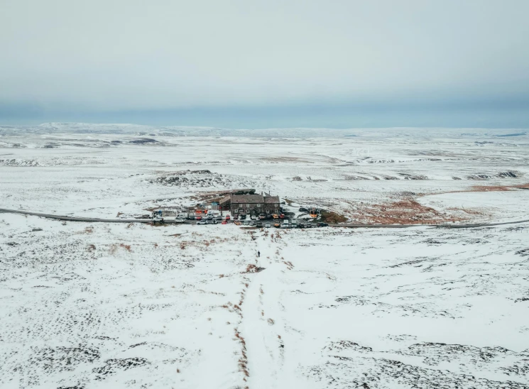 there is an aerial view of a snow covered field and town