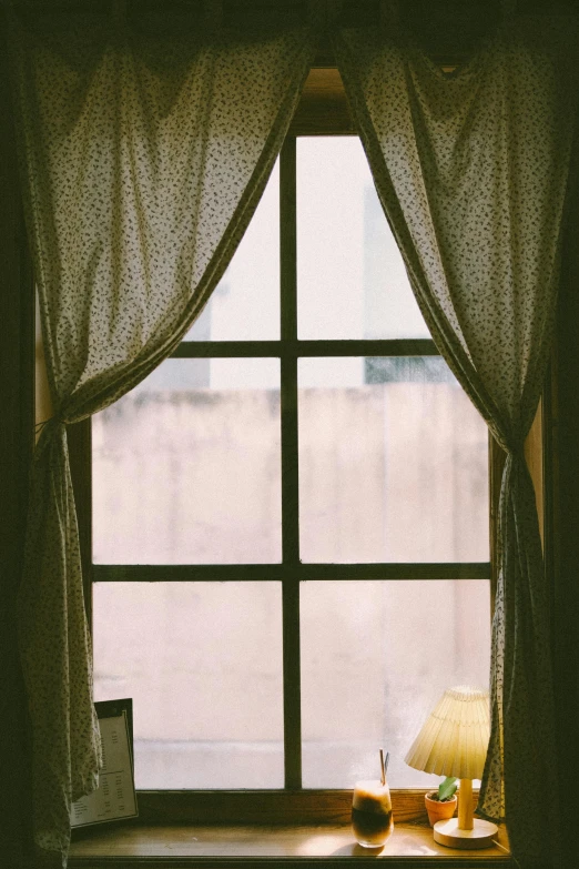 a window sill with a lamp and books on it