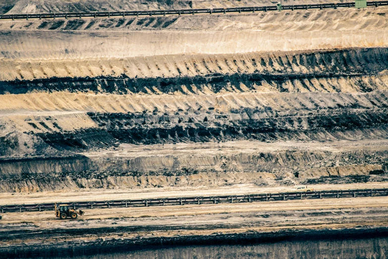 there is an oil truck in the dirt and some rocks