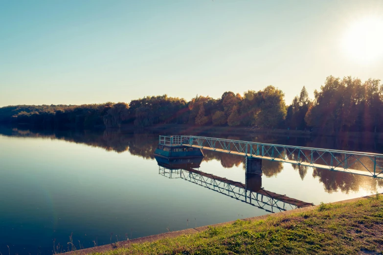 a boat sits on a pier on the river