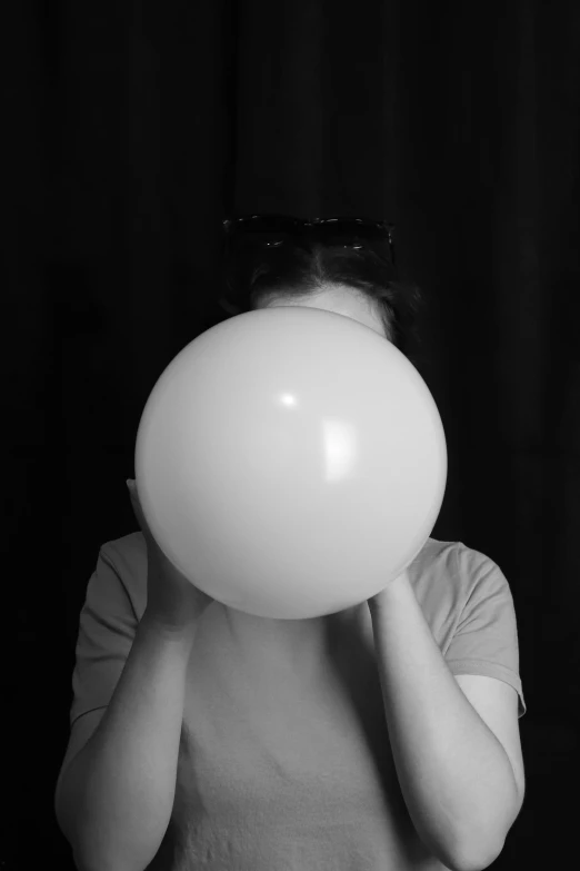 a person holding up a white bubble