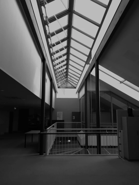 inside of an airplane terminal with skylight and stairs