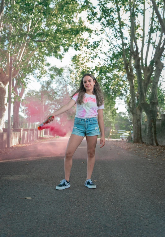 a beautiful young lady in shorts holding a red disc