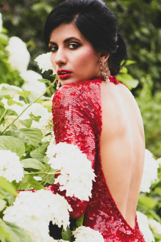 an attractive woman in a red dress with flowers