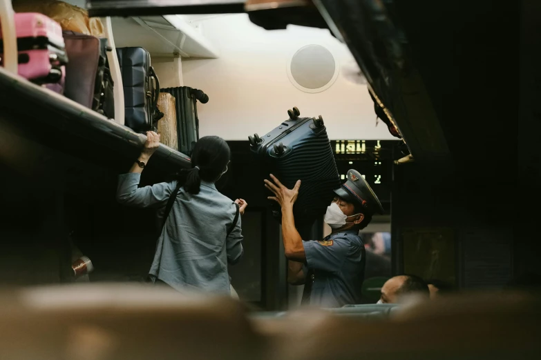 two men at a small shop carrying some suitcases