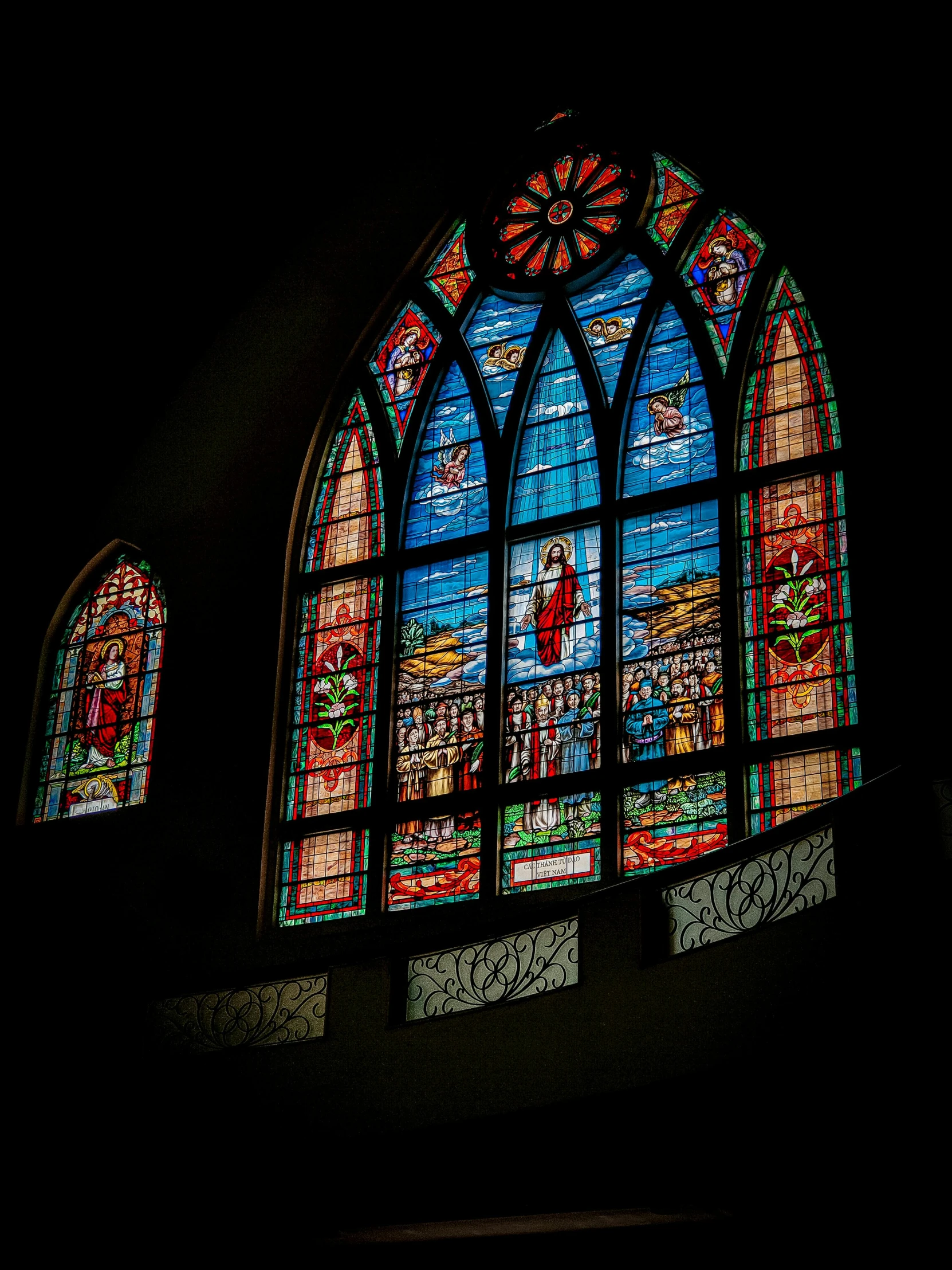 a stained glass window sitting in a dark room