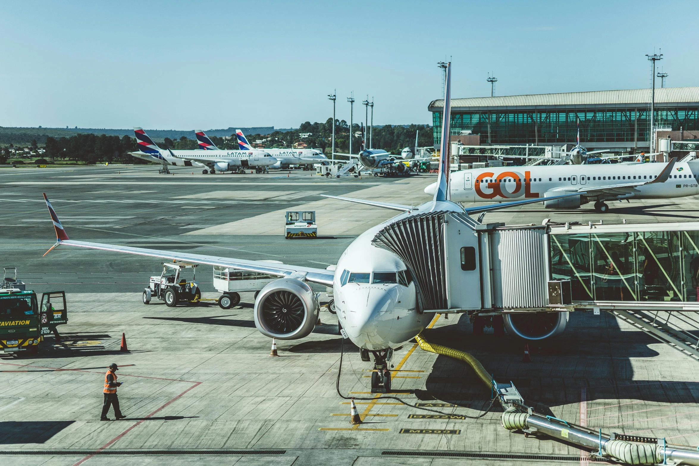 the jet is parked outside of the terminal