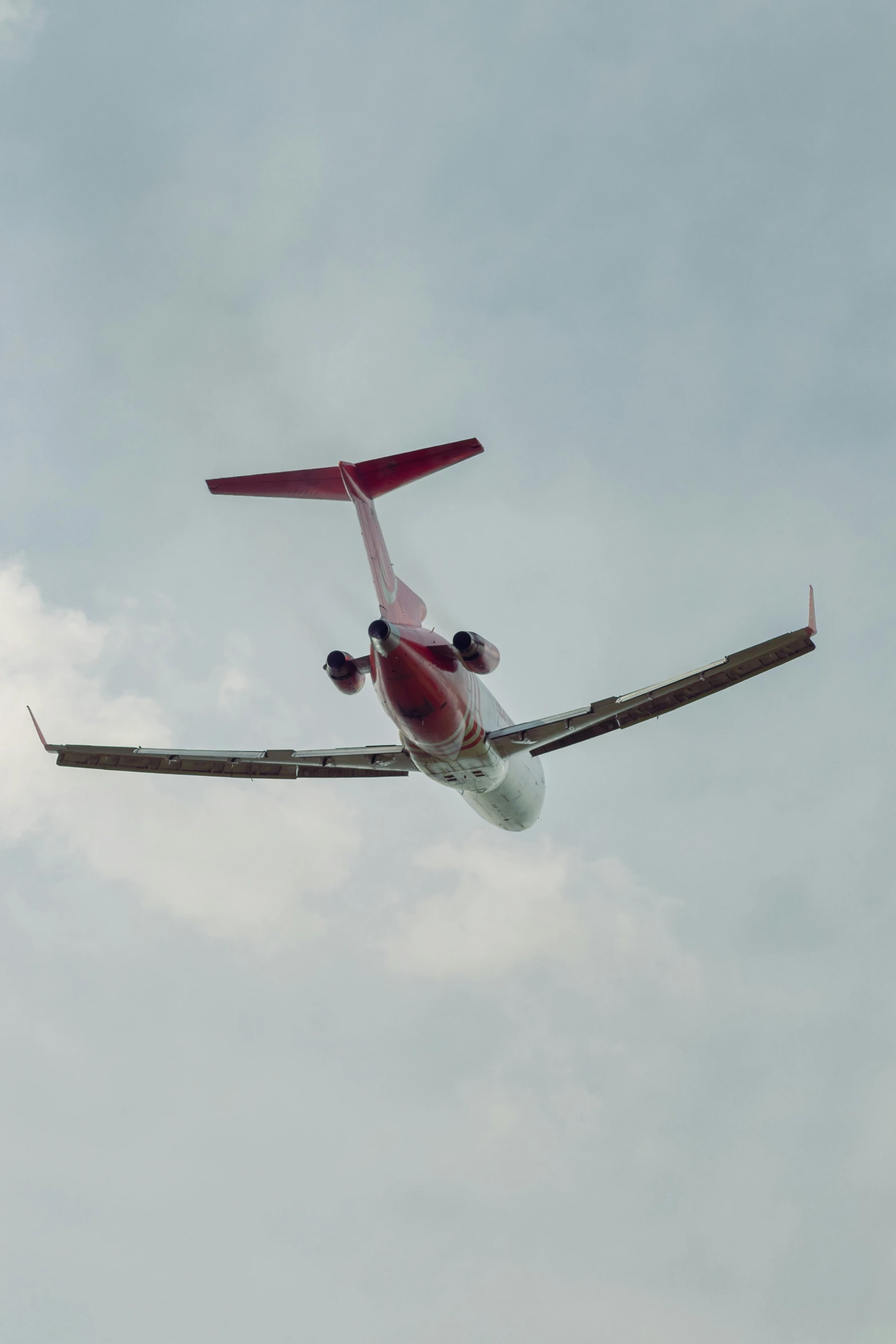 a white and red airplane in the air