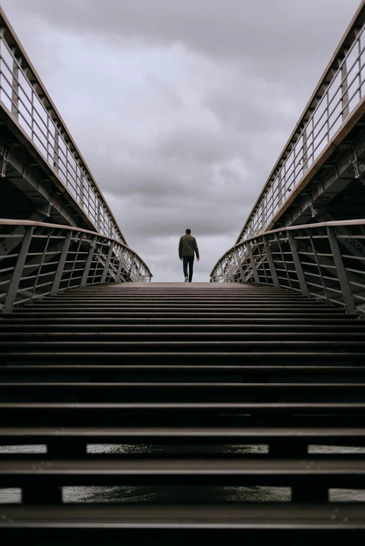 the man is walking over an empty metal stair