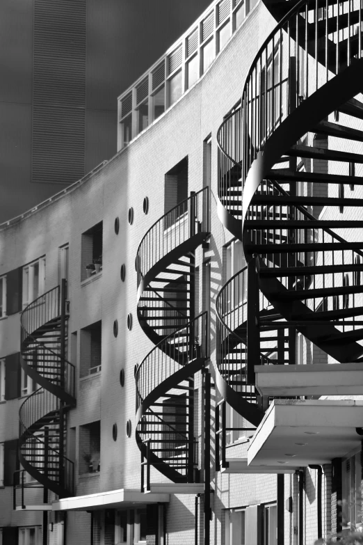 a large spiral staircase in front of a building