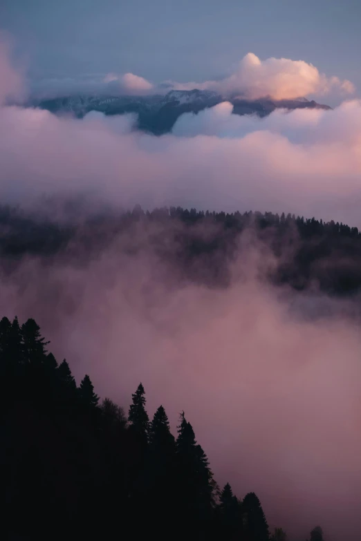 an aerial view of clouds rising from the ground