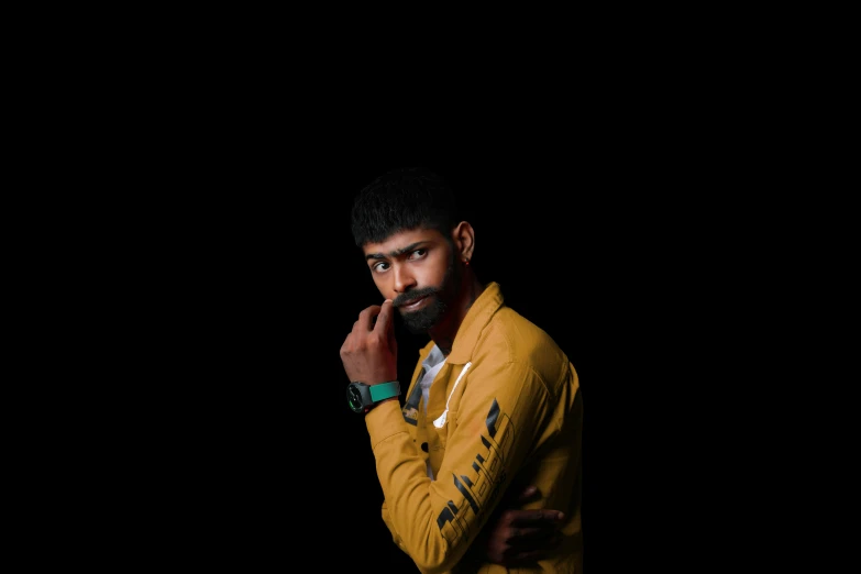 a young man is posing in a studio for his picture