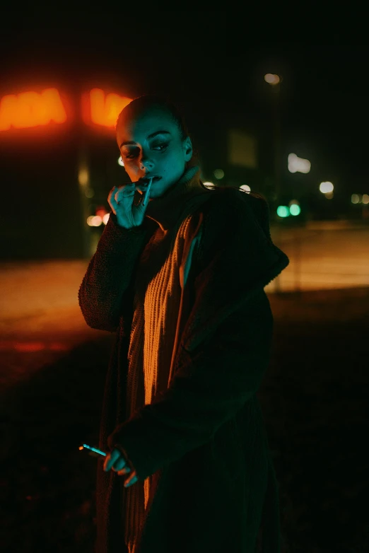 a person smoking a cigarette in the dark