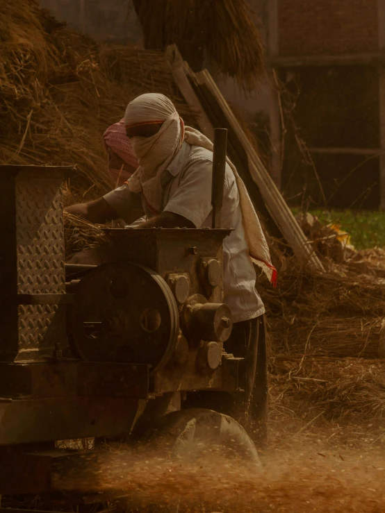 an old man sitting on a farm machine