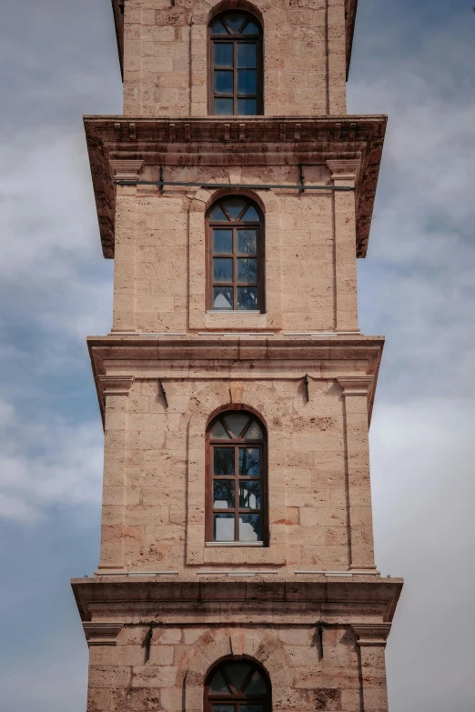 a tall building has three windows on each of it's sides